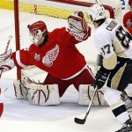 The puck gets by Detroit Red Wings goaltender Chris Osgood on a shot by Pittsburgh Penguins Marian Hossa as Sidney Crosby (87) looks on during first period of Game 5 of the NHL Stanley Cup Finals Monday, June 2, 2008 in Detroit. (AP Photo/The Canadian Press, Frank Gunn)