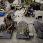 A Chinese mason works on tombstones for students who died in the May 12 earthquake in Luoshui Town of Shifang, China's southwest Sichuan province, Saturday, June 7, 2008. (AP Photo/Alexander F. Yuan)
