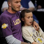 Los Angeles Galaxy soccer player David Beckham and his son Brooklyn sit courtside before the Boston Celtics played the Los Angeles Lakers in Game 3 of the NBA basketball finals Tuesday, June 10, 2008, in Los Angeles. (AP Photo/Kevork Djansezian)