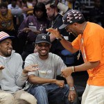 Kanye West, left, talks with filmmaker Spike Lee, right, and an unidentified friend before Game 3 of the NBA basketball finals between the Boston Celtics and Los Angeles Lakers on Tuesday, June 10, 2008, in Los Angeles. (AP Photo/Mark J. Terrill)