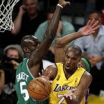 Los Angeles Lakers forward Kobe Bryant passes the ball as Boston Celtics forward Kevin Garnett defends in the first half of Game 4 of the NBA basketball finals Thursday.
