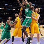 Boston Celtics forward Kevin Garnett (5) drives to the basket against Los Angeles Lakers forward Lamar Odom, second from left, and Pau Gasol (16), of Spain, during the first half of Game 4 of the NBA basketball finals Thursday.