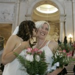 Sharon Papo, left, kisses her partner Amber Weiss, right, before their wedding at City Hall in San Francisco, Tuesday, June 17, 2008. County clerk offices opened their doors Tuesday to hundreds of gay and lesbian couples with appointments to secure marriage licenses and exchange vows on the first full day same-sex nuptials were legal throughout California. (AP Photo/Eric Risberg)