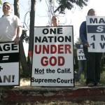 Demonstrators carrying signs against same-sex marriage are seen across from the Sacramento County Clerk/Recorders office where dozens of gay and lesbian couples were waiting to obtain marriage licenses in Sacramento, Calif. on Tuesday, June 17, 2008. (AP Photo/Rich Pedroncelli)