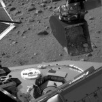 This image released by NASA taken by NASA's Phoenix Mars Lander's Surface Stereo Imager on Thursday, June 5, 2008, shows the Robotic Arm scoop containing a soil sample poised over the partially open door of the Thermal and Evolved-Gas Analyzer's number four cell, or oven. (AP Photo/NASA/JPL-Caltech/University of Arizona/Texas A&M University)
