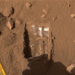 This color image released by NASA and acquired by NASA's Phoenix Mars Lander's Surface Stereo Imager on Friday, June 13, 2008, shows one trench informally called "Dodo-Goldilocks" after two digs on June 12, by Phoenix's Robotic Arm. Shallow trenches excavated by the lander's backhoe-like robotic arm have turned up specks and at times even stripes of mysterious white material mixed in with the clumpy, reddish dirt. (AP Photo/NASA/JPL/CalTech)
