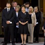 Maureen Orth, widow of Tim Russert, center, and their son, Luke Russert, watch as the casket of the Meet the Press host is carried from Holy Trinity Church in Washington, Wednesday, June 18, 2008, following a funeral mass. At top right are former General Electric Chief Executive Officer Jack Welch and NBC "Today" show host Matt Lauer. (AP Photo/J. Scott Applewhite)
