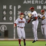 Arizona Diamondbacks rightfielder Justin Upton, center, leaps as he celebrates a 2-1 win over the Boston Red Sox with teammates Eric Byrnes, left, and Chris Young, right, after their MLB baseball game at Fenway Park in Boston, Monday June 23, 2008. (AP Photo/Charles Krupa)