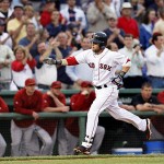 Boston Red Sox' Dustin Pedroia reaches for congratulations as he rounds third after hitting a solo home run against the Arizona Diamondbacks in the first inning of their baseball game at Fenway Park in Boston Tuesday.