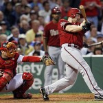 Arizona Diamondbacks' Chad Tracy follows through on a three-run homer as Boston Red Sox catcher Jason Varitek , left, watches in the third inning of a MLB baseball game at Fenway Park in Boston on Tuesday.