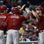 Arizona Diamondbacks' Chad Tracy, right, is congratulated by teammates Conor Jackson (34) and Orlando Hudson (1) who scored on his three-run homer against the Boston Red Sox in the third inning of a MLB baseball game at Fenway Park in Boston on Tuesday.
