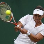 Australia's Casey Dellacgua returns to France's Pauline Parmentier in their Women's Singles, second round match at Wimbledon, Wednesday.