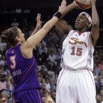 Connecticut Sun's Asjha Jones, right, goes up for a shot as the Phoenix Sun's Diana Taurasi tries to stop her during the first half a WNBA basketball game in Uncasville, Conn., Sunday.