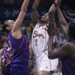 Phoenix Mercury's Diana Taurasi, left, guards Connecticut Sun's Amber Holt as she tries for a shot during the first half a WNBA basketball game in Uncasville, Conn., Sunday.