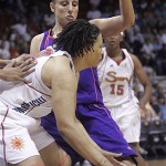 Connecticut Sun's Tamka Whitmore, front, is guarded by Phoenix Sun's Diana Taurasi during the first half a WNBA basketball game in Uncasville, Conn., Sunday.
