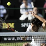 Croatia's Mario Ancic is hit with the ball, during his Men's Singles quarterfinal against Switzerland's Roger Federer, on the Centre Court at Wimbledon, Wednesday, July 2, 2008. (AP Photo/Peter Van Den Berg)
