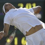 Spain's Feliciano Lopez serves to Marat Safin of Russia, during their Men's Singles quarterfinal on the Number One Court at Wimbledon, Wednesday, July 2, 2008. (AP Photo/Alastair Grant)
