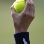 A ball boy hold up a ball, during the Men's Singles quarterfinal between Croatia's Mario Ancic and Switzerland's Roger Federer, on the Centre Court at Wimbledon, Wednesday, July 2, 2008. (AP Photo/Kirsty Wigglesworth)
