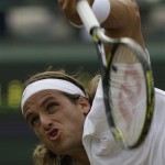 Spain's Feliciano Lopez serves to Marat Safin of Russia, during their Men's Singles quarterfinal on the Number One Court at Wimbledon, Wednesday, July 2, 2008. (AP Photo/Alastair Grant)

