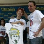 Takeru Kobayashi, left, of Japan poses for photographs with last years hot dog eating champion Joey Chestnut, of San Jose, Calif., during the weigh in news conference for the Nathan's Famous International Hot Dog Eating Contest Thursday, July 3, 2008 in New York. The contest will take place Friday July 4, 2008 in the Coney Island section of the Brooklyn borough of New York. (AP Photo/Frank Franklin II)

