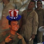 A U.S. Marine, from the 24th Marine Expeditionary Unit, poses while attending a special lunch to celebrate the Fourth of July at a forward operating base in southern Afghanistan, Friday, July 4, 2008. (AP Photo/Rafiq Maqbool)