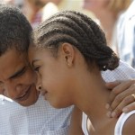 Democratic presidential candidate, Sen. Barack Obama talks to his daughter Malia as they watch an Independence Day parade in Butte, Mont., Friday, July 4, 2008. (AP Photo/Jae C. Hong)
