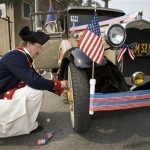 Kent Gregory, of the Sons of the American Revolution, puts bunting on a Model A Ford before the annual Fourth of July parade in Huntington Beach, Calif., Friday, July 4, 2008. (AP Photo/Mark Avery)
