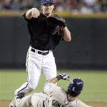 Arizona Diamondbacks shortstop Stephen Drew, top, throws to first after forcing out San Diego Padres' Edgar Gonzalez, bottom, to complete a double play in the first inning of a baseball game Saturday, July 5, 2008, in Phoenix. (AP Photo/Paul Connors)