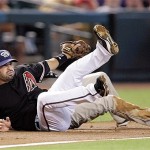 Arizona Diamondbacks third baseman Augie Ojeda, front, his knocked to the ground after colliding with San Diego Padres' Scott Hairston, rear, after he was tagged out by Ojeda in the first inning of a baseball game Saturday, July 5, 2008, in Phoenix.(AP Photo/Paul Connors)