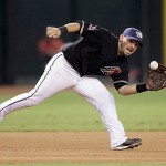 Arizona Diamondbacks third baseman Augie Ojeda lunges to his left to field a ground ball hit by San Diego Padres' Chase Headley in the fourth inning of a baseball game Saturday, July 5, 2008, in Phoenix.(AP Photo/Paul Connors)