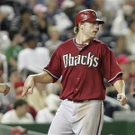 Arizona Diamondbacks' Mark Reynolds, center, glances back to third base after scoring on a single to center field by teammate Robby Hammock during the sixth inning of an MLB baseball game against the Washington Nationals, Tuesday.