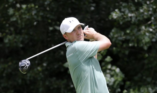 Jordan Spieth watches his tee shot on the second hole during the final round of the John Deere Clas...