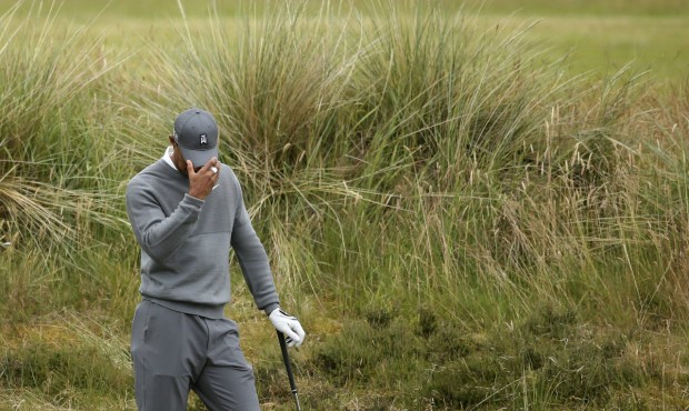United States’ Tiger Woods prepares to take a shot from the rough on the fifth hole during the fi...
