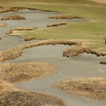 
              Tiger Woods looks at his ball in a bunker on the 14th hole during the second round of the U.S. Open golf tournament at Chambers Bay on Friday, June 19, 2015 in University Place, Wash. (AP Photo/Charlie Riedel)
            