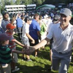 
              Jordan Spieth, right, celebrates with fans after finishing the third round of the John Deere Classic golf tournament Saturday, July 11, 2015, in Silvis, Ill. (AP Photo/Charles Rex Arbogast)
            