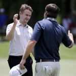 
              Russell Knox, left, of Scotland, shakes hands with playing partner Jim Renner on the ninth green following their second round of the St. Jude Classic golf tournament Friday, June 12, 2015, in Memphis, Tenn. (AP Photo/Mark Humphrey)
            