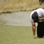 
              Jason Day, of Australia, kneels while waiting to putt on the ninth hole after having collapsed earlier in the fairway during the second round of the U.S. Open golf tournament at Chambers Bay on Friday, June 19, 2015 in University Place, Wash. (AP Photo/Ted S. Warren)
            
