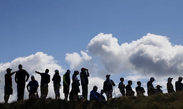Fans watch along the fifth fairway during the second round of the U.S. Open golf tournament at Cham...