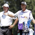 
              Phil Mickelson,.left, talks with his caddie Jim Mackay on the eighth tee during the first round of the St. Jude Classic golf tournament Thursday, June 11, 2015, in Memphis, Tenn. Mickelson bogeyed the hole. (AP Photo/Mark Humphrey)
            