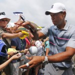 
              Tiger Woods signs autographs for fans after the pro-am for the Greenbrier Classic golf tournament at the Greenbrier Resort  in White Sulphur Springs, W.Va., Wednesday, July 1, 2015.  (AP Photo/Steve Helber)
            