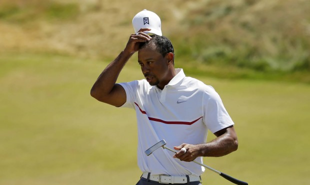 Tiger Woods removes his hat after his second round in the U.S. Open golf tournament at Chambers Bay...