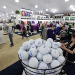 
              Shoppers check out giant souvenir rubber golf balls and other items as they shop in the merchandise pavilion at Chambers Bay golf course in University Place, Wash., Thursday, June 11, 2015. Chambers Bay will host the U.S. Open Championship next week, but the merchandise store and some other non-course areas are open to the public through this weekend. (AP Photo/Ted S. Warren)
            