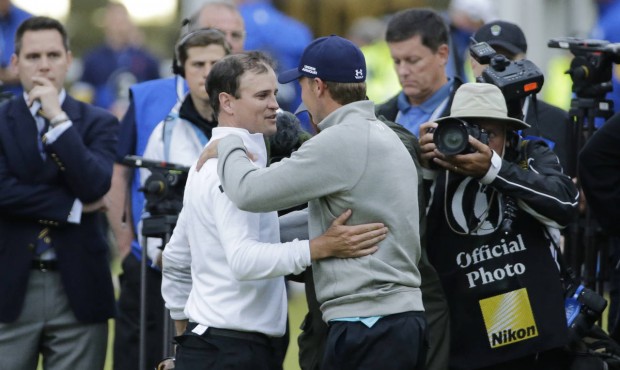 United States’ Zach Johnson, left, is congratulated by United States’ Jordan Spieth aft...