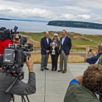 
              FILE - In this June 27, 2014, file photo, Mike Davis, left, executive director of U.S. Golf Association, Pierce County Executive Pat McCarthy, center, and USGA vice president Dan Burton pose with a U.S Open Championship trophy during a news conference at Chambers Bay Golf Course in University Place, Wash. Mike Davis hasn't caused this much consternation since he spoke to PGA Tour players about the evils on the long putter. Only this time, he was extolling the virtues of Chambers Bay. (AP Photo/The News Tribune, Peter Haley, File)
            