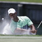 
              Tiger Woods hits out of the bunker on the 18th hole during the third round of The Players Championship golf tournament Saturday, May 9, 2015, in Ponte Vedra Beach, Fla. (AP Photo/John Raoux)
            