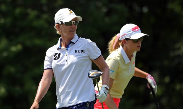 Karrie Webb, of Australia, watches her tee shot along with Paula Creamer, right, on the 13th tee du...