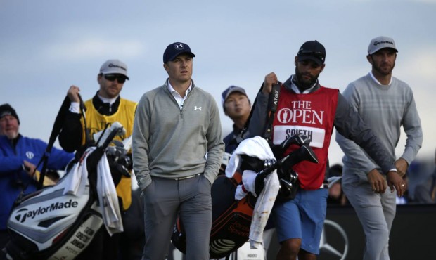 United States’ Jordan Spieth, front left, and United States’ Dustin Johnson, right, wal...