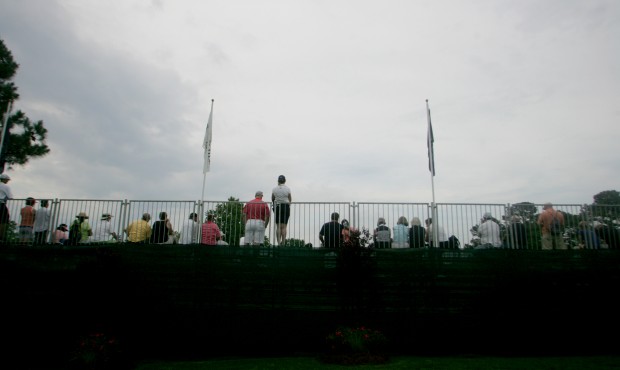 Spectators watch golfers on the 18th hole during the final round of the LPGA Tour’s Kingsmill...
