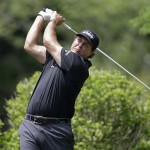 
              Phil Mickelson watches his tee shot on the fifth hole during the second round of the Wells Fargo Championship golf tournament at Quail Hollow Club in Charlotte, N.C., Friday, May 15, 2015. (AP Photo/Bob Leverone)
            