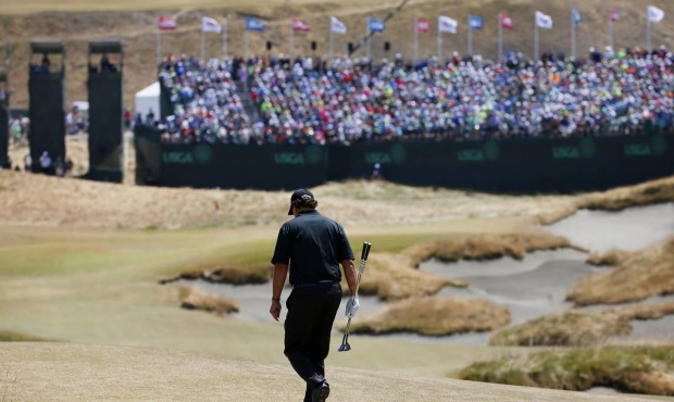 Phil Mickelson walks to 18th green during the final round of the U.S. Open golf tournament at Chamb...